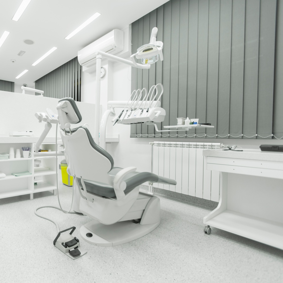 A dental examination chair in a clinical office.