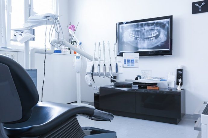 Dental operatory with a patient chair and an X-ray monitor