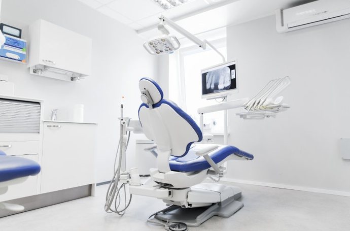 Blue dental patient chair in a bright operatory